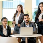 Business team in formal corporate office uniforms working together